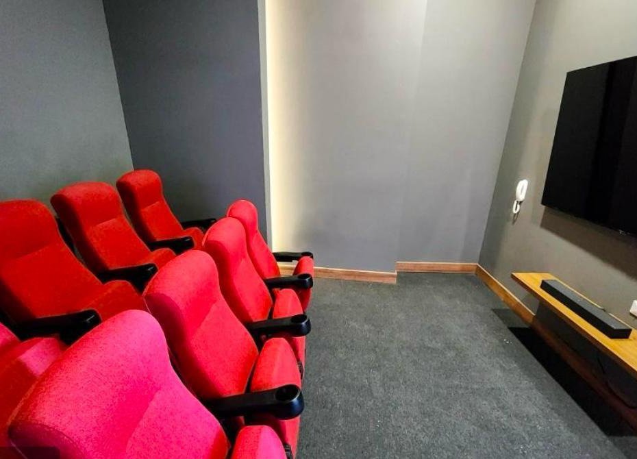 Sala de cine privada del edificio con butacas rojas